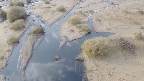 the oil spill over a sandy landscape - close up