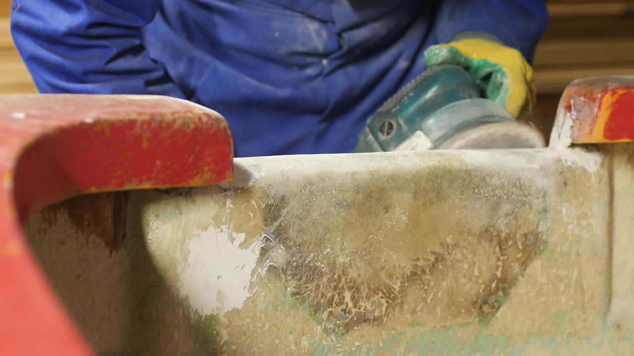 Sanding fiberglass boat transom and gunwale with orbital sander