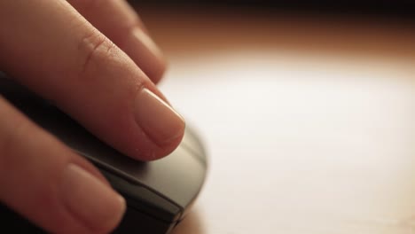 close-up of a hand gently resting on a computer mouse, focusing on daily technology use