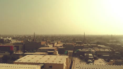 Aerial-Over-Karachi-Cityscape-During-Golden-Yellow-Sunrise