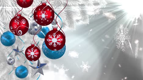 Animation-of-christmas-boubles-and-snow-falling-over-glowing-light