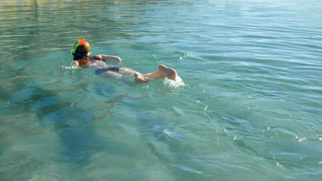 Woman-swimming-in-the-water-at-beach-4k