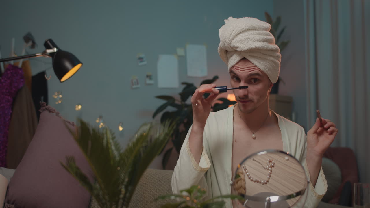 Man applying mascara in front of mirror