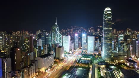 vibrant lights illuminate the hong kong skyline as skyscrapers tower above busy streets. the night scene captures the energy and beauty of the city, showcasing its architectural marvels.