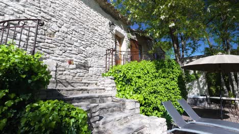 charming entryway of a stone house with climbing plants and relaxing outdoor space