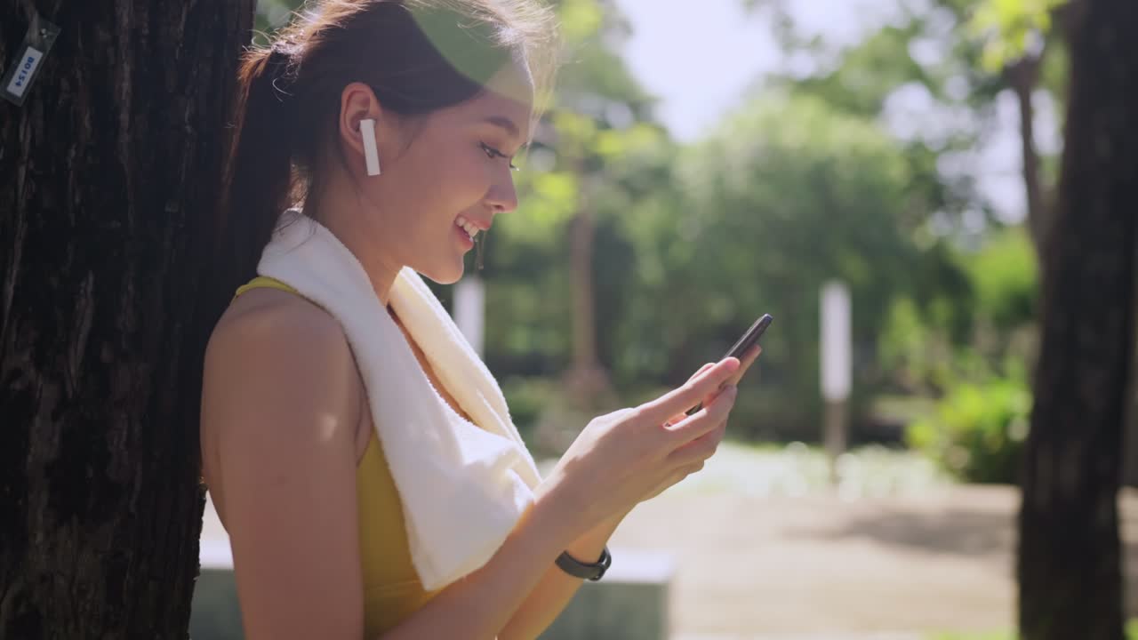 sport active asian female sport cloth setting up smartphone playing prepare for her running routine workout morning healthy lifestyle,smiling sport woman setting runing route in her application map