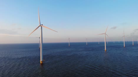 green energy windmill turbine in ocean, aerial view of windmill park in the netherlands