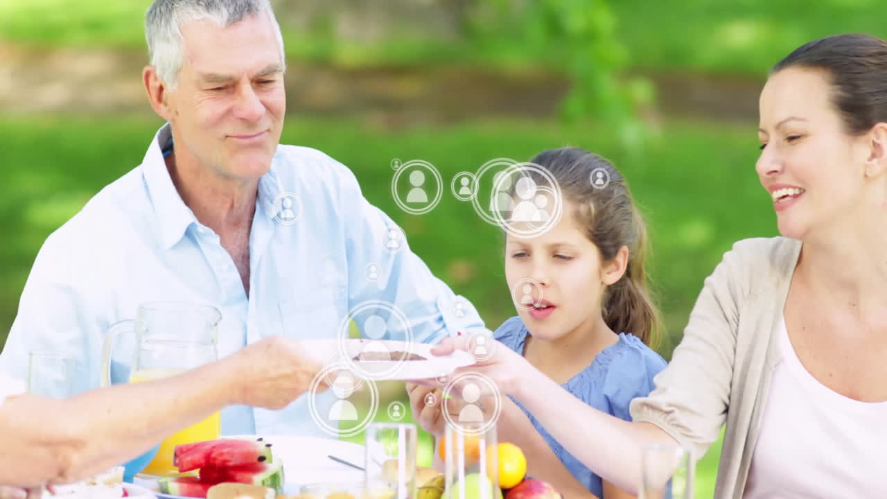 family gathering around picnic table, showing animated health chart with juice and watermelon icons