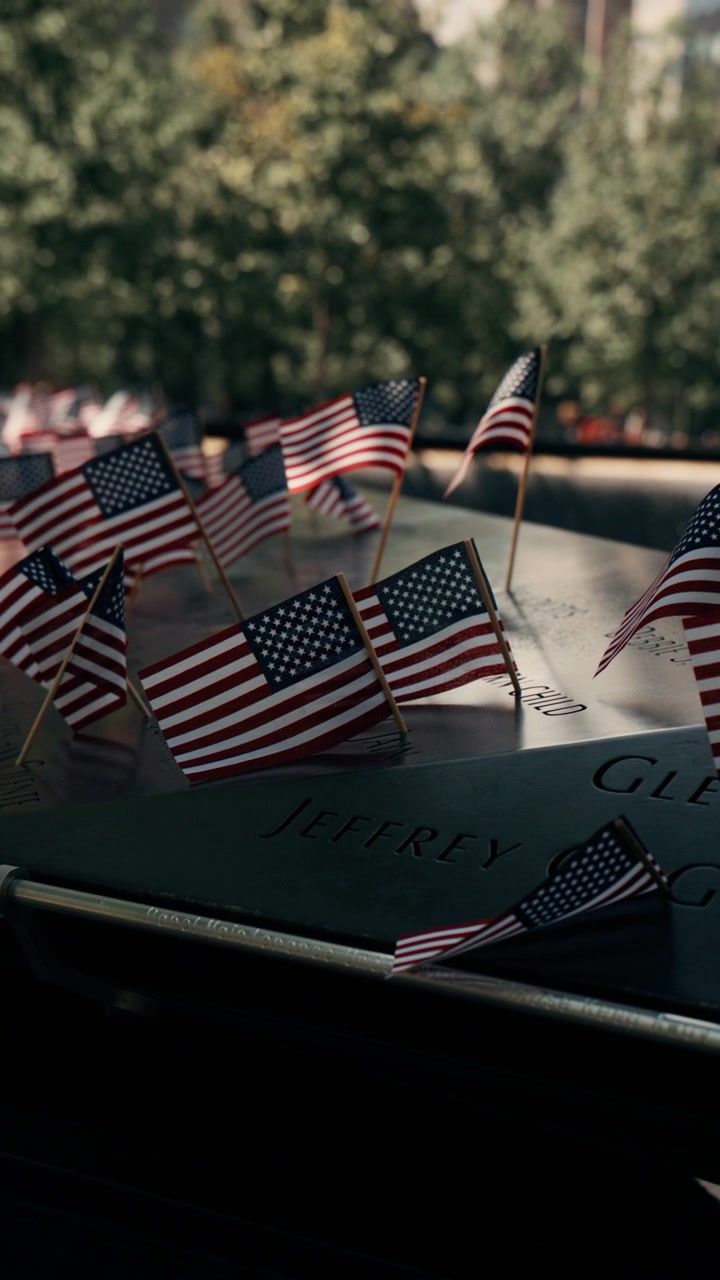 Usa flags at memorial ground zero with cityscape