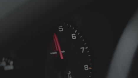 Close-up-shot-of-a-speedometer-in-a-car-revving-up-and-down-with-a-red-arrow-LOG