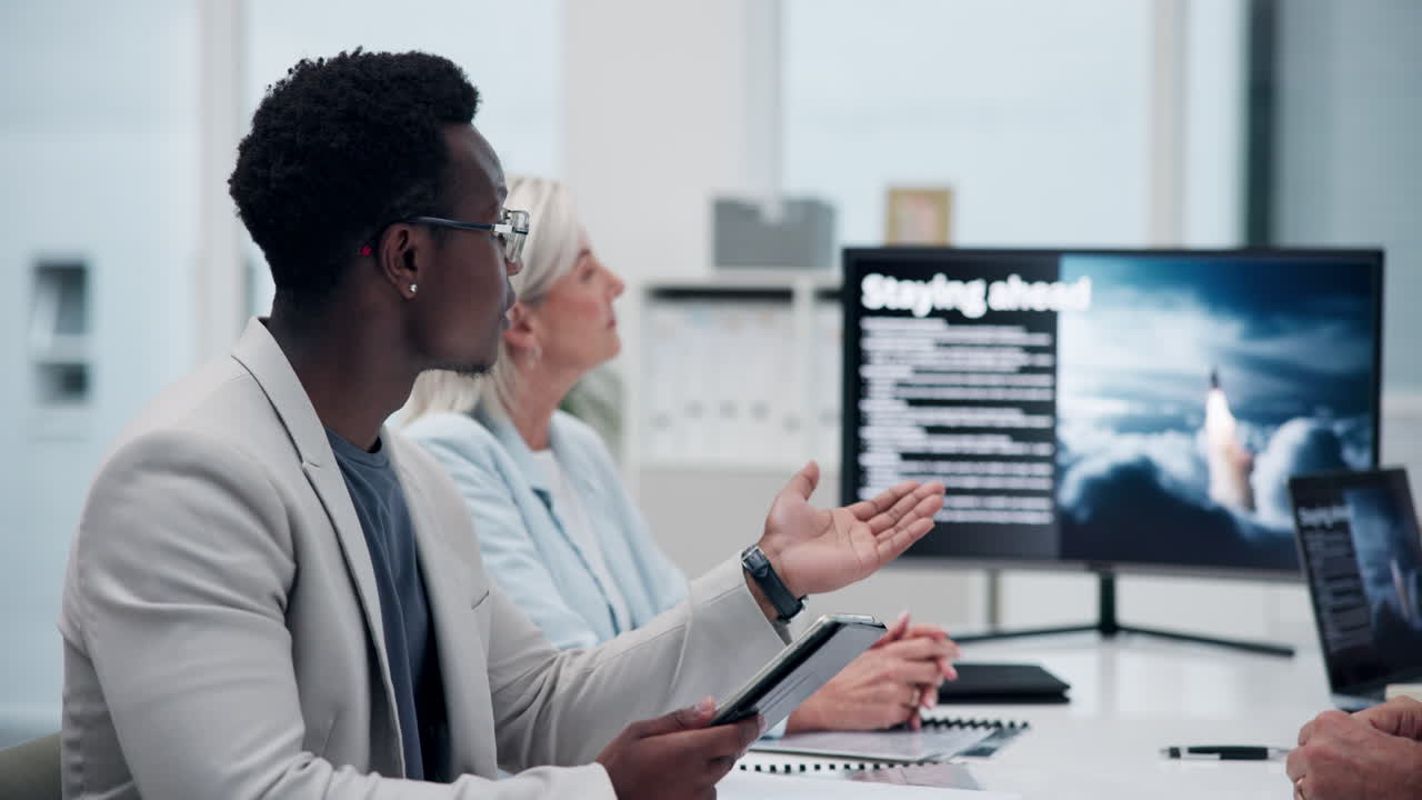 Business professionals collaborate during a meeting, discussing strategies for staying ahead in a technology-driven environment