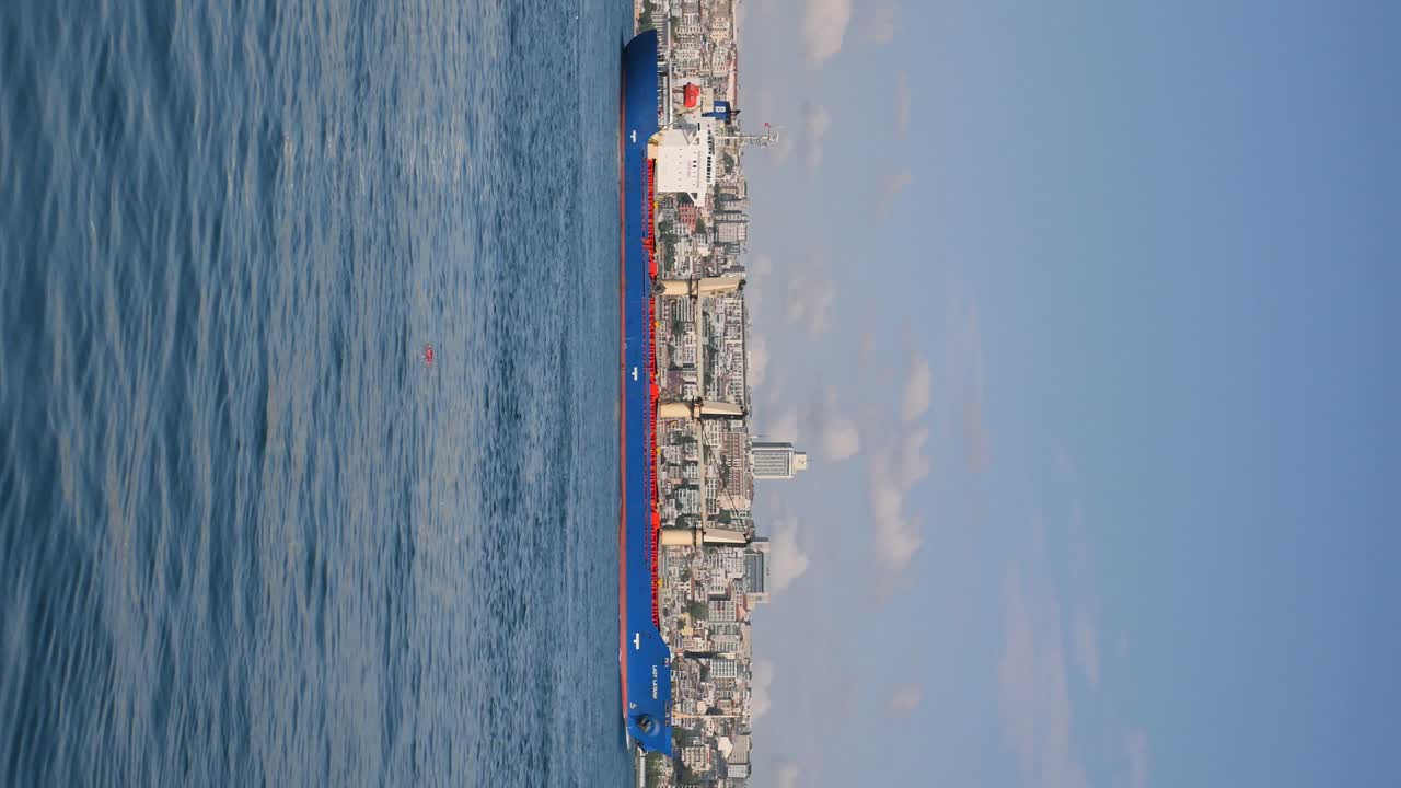 Ship docked near a city by the sea