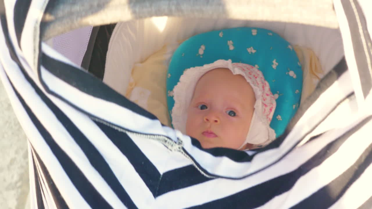 아기 소녀 와 함께 아기 바구니 를 밀고 있다