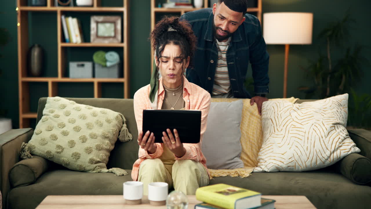Couple using a tablet at home