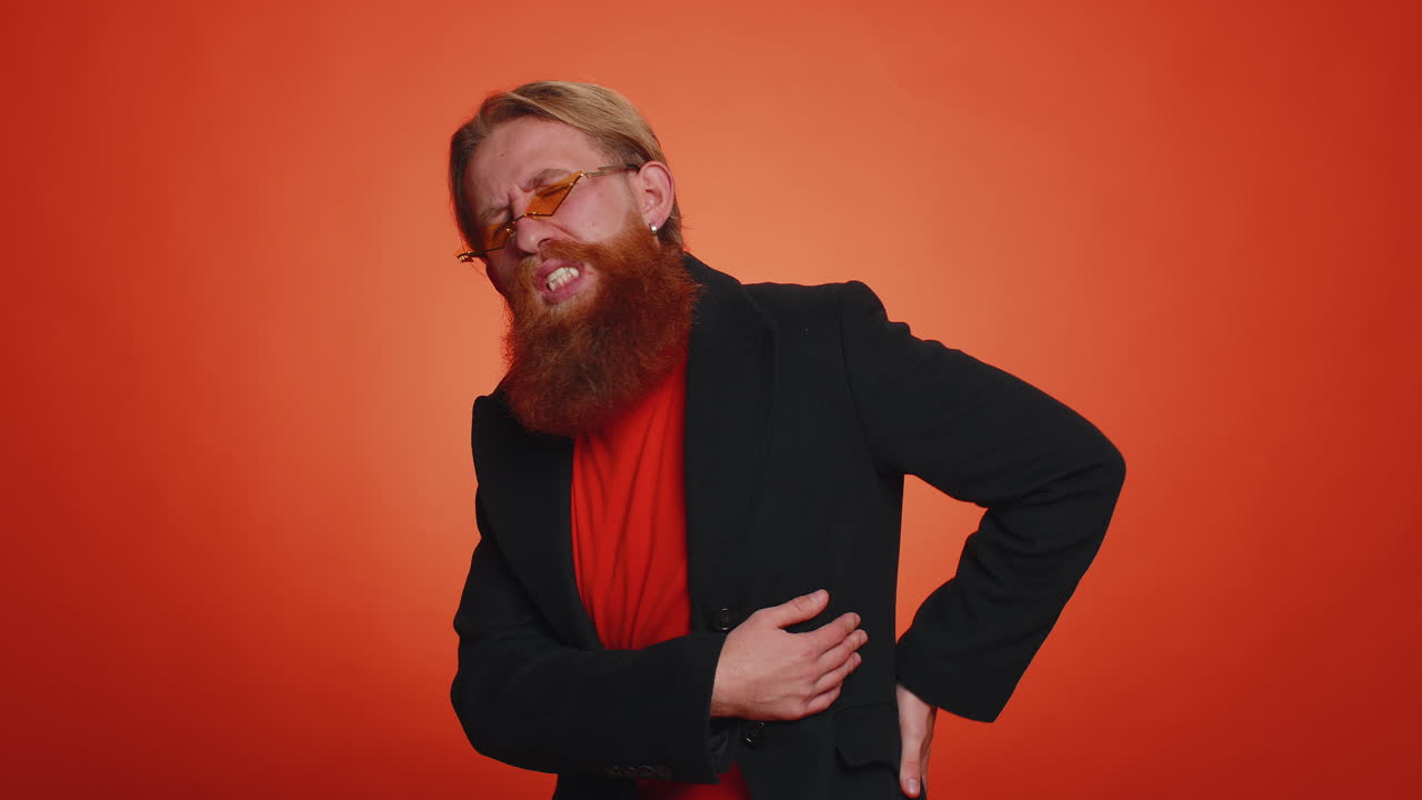 Man touching injured sore back, backache, suffering lower lumbar discomfort, muscle pain of overwork