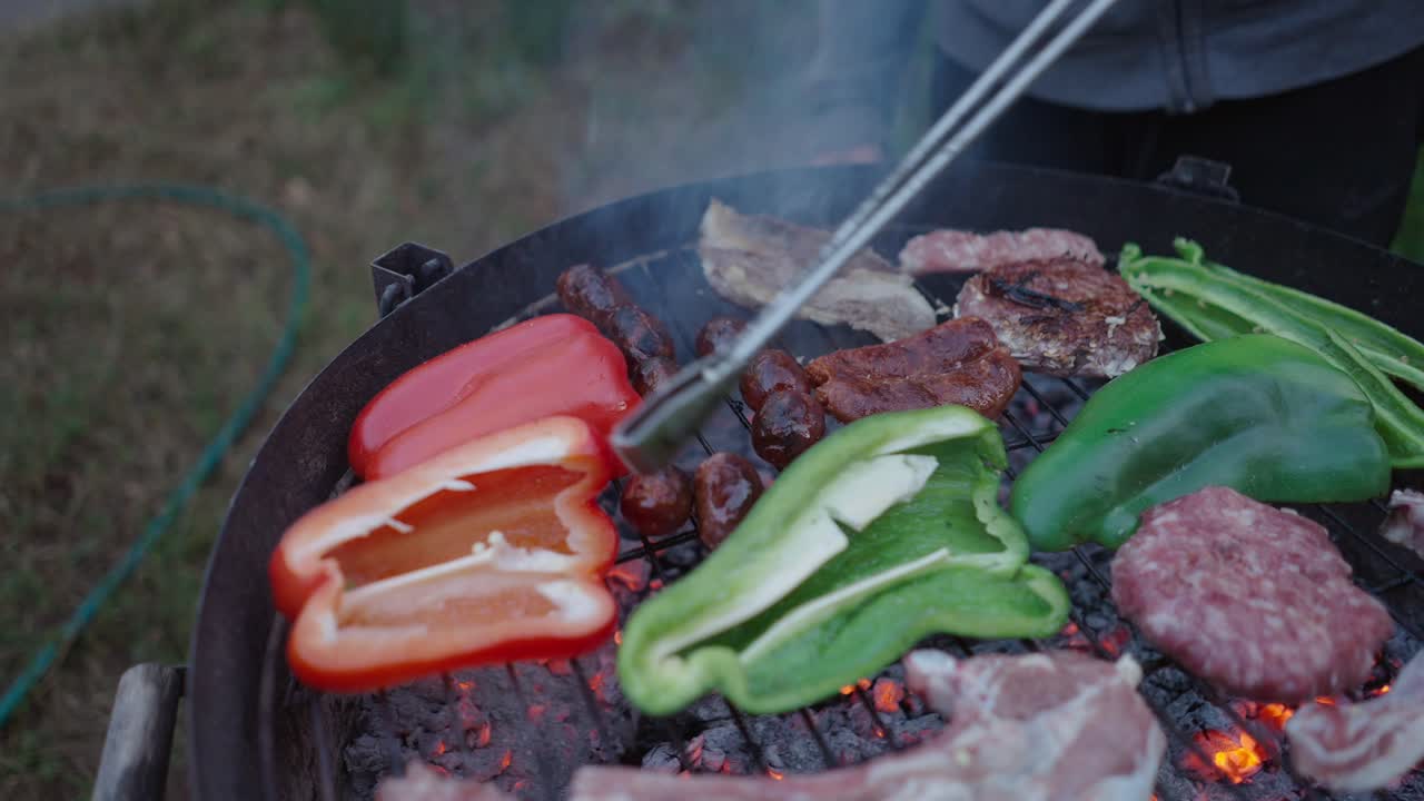 Outdoor Barbecue with Various Meats and Vegetables