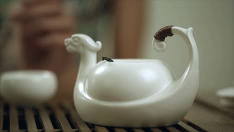 female hand brew tea in teapot cup. close up of brewing tea in teapot