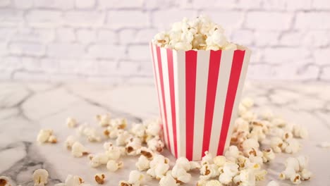 popcorn in a red and white striped box