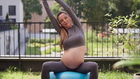 pregnant woman during the exercise at the garden