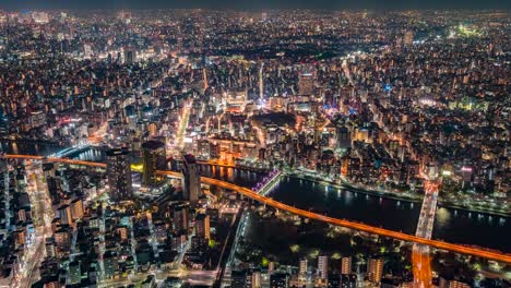 tokyo japan skytree view from the observation tower in sumida at night timelapse looking at the city below with cars and trains going past over the river in the darkness