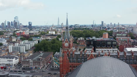 Elevated-static-shot-of-historic-brick-tower-contrasting-with-modern-tall-buildings-in-City-financial-hub.-London,-UK