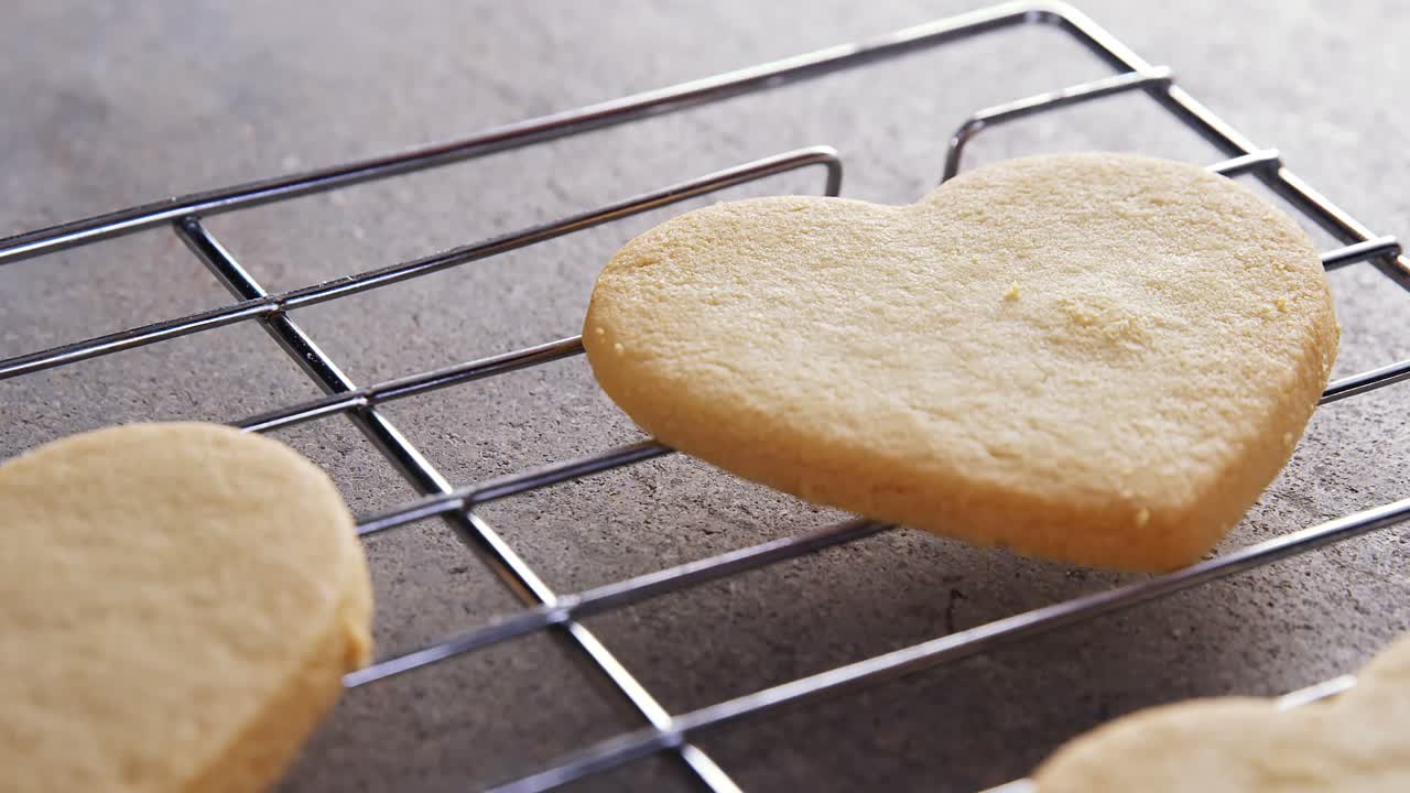 Raw heart shape cookies with sugar icing on baking tray 4k
