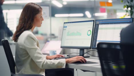 joven mujer de negocios segura usando computadora de escritorio en una oficina moderna con colegas. elegante y hermosa gerente que trabaja en proyectos comerciales, financieros y de marketing. especialista en equipos diversos.