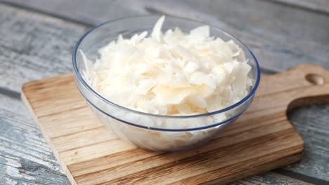 Fresh-coconut-flakes-in-a-bowl-on-a-table-cloth