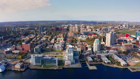 aerial drone shot over halifax downtown, nova scotia, canada.
high view of the cityscape, ocean and the urban buildings.
