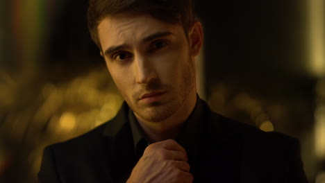 young man smiling at camera indoors