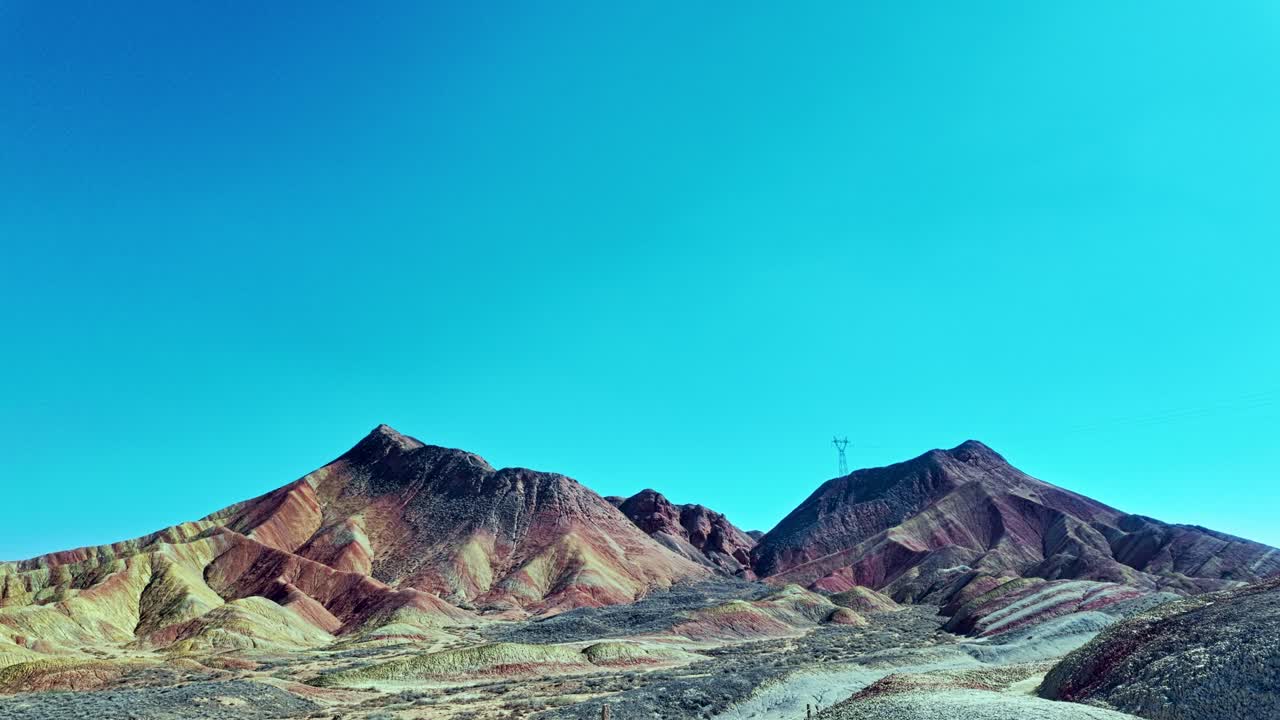 Zhangye, Gansu Province, China - Colorful Layered Mountains Rise Beneath a Clear Blue Sky in this Striking Natural Landscape - Pan Shot