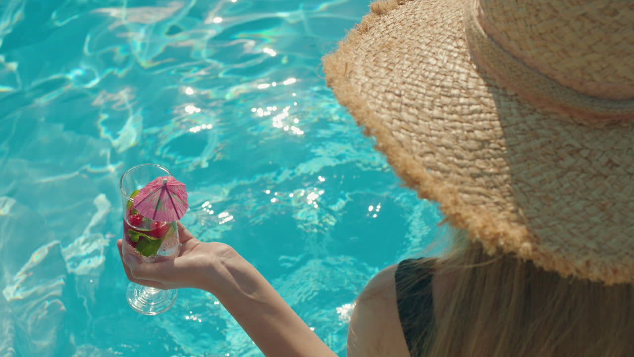 Woman Relaxing by the Pool with a Cocktail