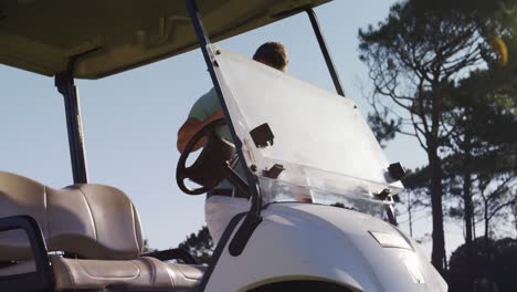 golf player getting into golf buggy