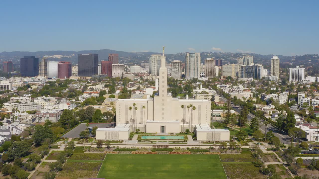 Beautiful aerial fly over temple with golden statue in the city