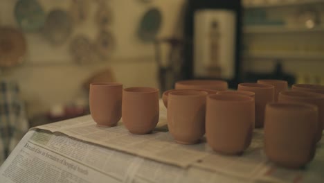 clay glasses are left to dry. blurred background.