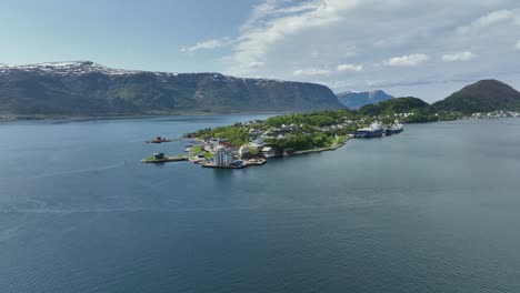 aspoy and slinningen island in alesund norway - approaching aerial above sea during summer