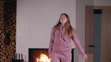 woman dancing in front of fireplace