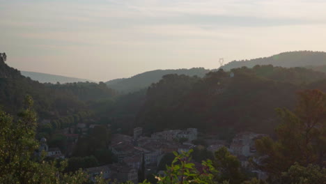 a slow pan in the morning over a village located in a valley in the cote d'azur region in france