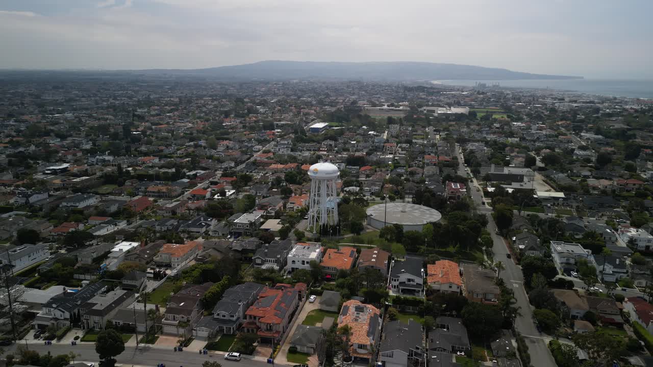 4K drone footage of Manhattan Beach Water Tower in Los Angeles South Bay, featuring aerial views of the iconic tower, coastline, beaches, Pacific Ocean, and surrounding coastal cityscape