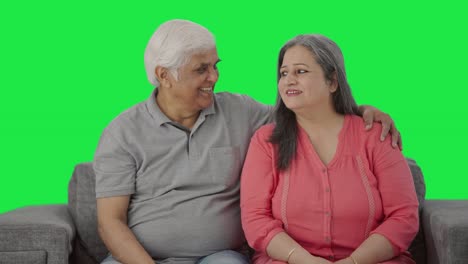 Happy-Indian-old-couple-watching-TV-Green-screen