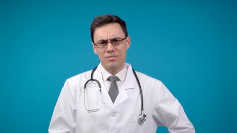 serious male doctor pointing at camera