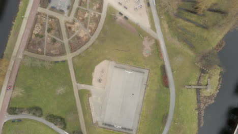 top down aerial of children playing in suburban park