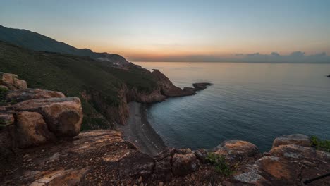 time lapse video of beautiful sunrise over coastline of sai kung. view of islands and coastline at sai kung hong kong. geographical lanscape and rugged coastline of island