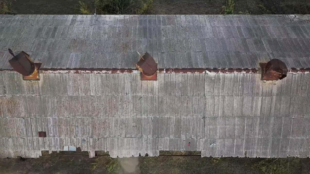 Rusty metal roof abandoned building drone shot 4k