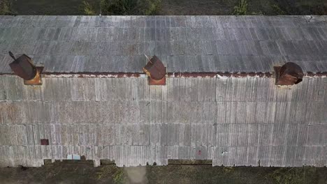 rusty metal roof abandoned building drone shot 4k