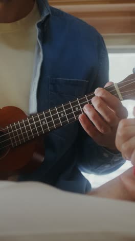 man playing ukulele