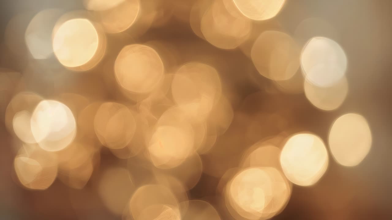 Shimmering cluster of warm decor lights moving subtly inside room, camera shift creating bokeh