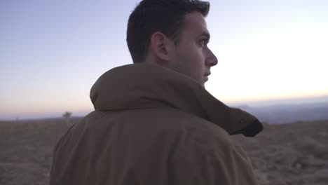 Man looks at the horizon during a desert sunrise