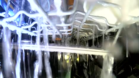 inside working dishwasher, cleaning dishes with spraying water, gopro