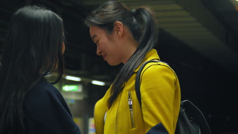 Two-Young-Female-Friends-Hugging-As-They-Say-Goodbye-On-Underground-Train-Station-Platform-2